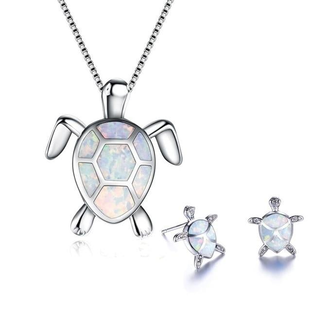 Sparkling women's silver sea turtle pendant necklace featuring a vibrant opal. Ocean-themed gift for her.