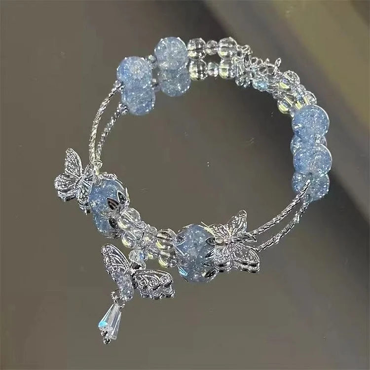 Women's handcrafted sky blue butterfly bracelet with intricate floral details. Elegant summer jewelry for her.