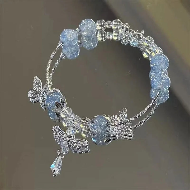 Women's handcrafted sky blue butterfly bracelet with intricate floral details. Elegant summer jewelry for her.