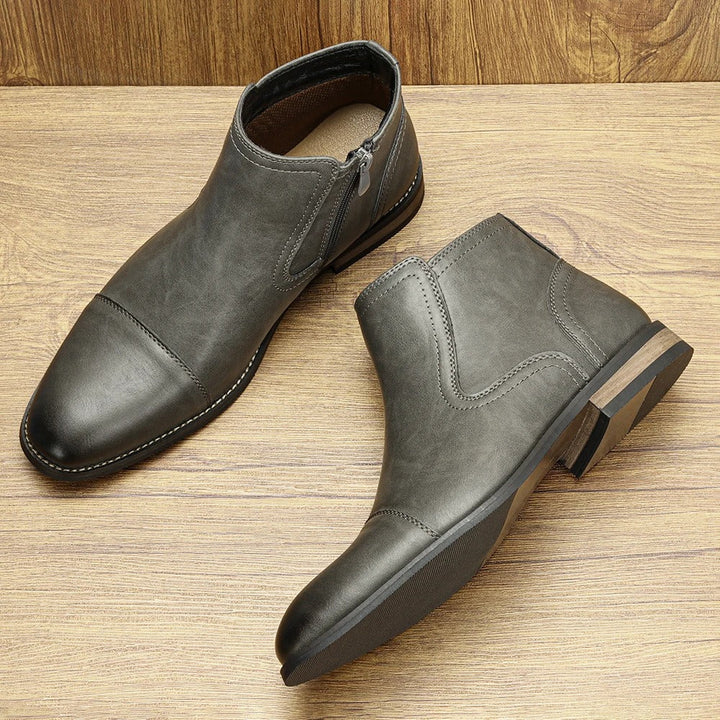 Classic black leather men's Chelsea boots with side-zip, versatile for casual or dress.