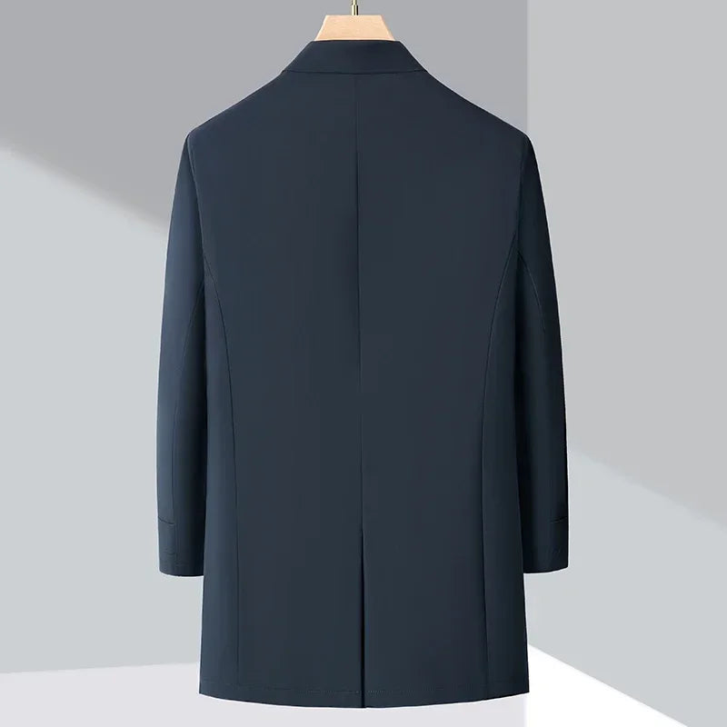 Modern men's blue insulated trench coat, ideal for cold weather urban commutes and sleek fall fashion outerwear.