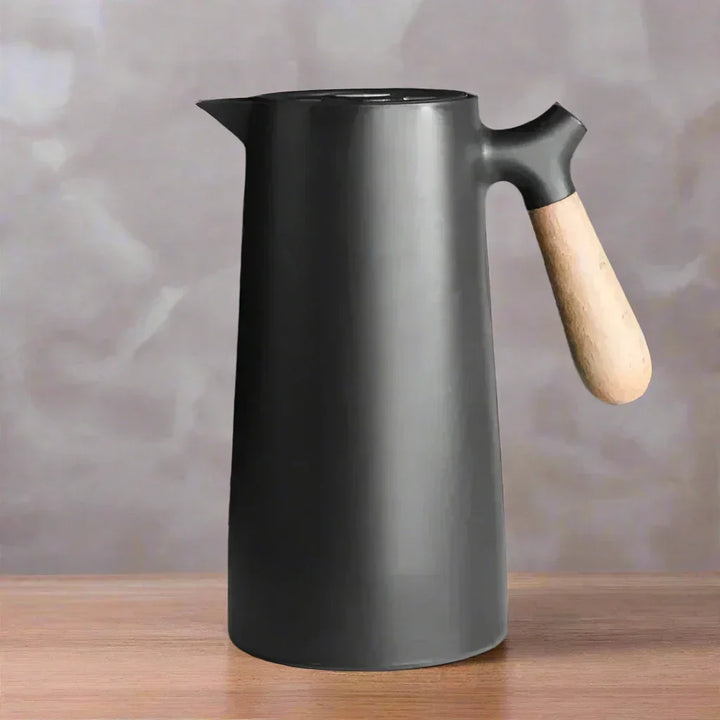 Sleek NordicTherm stainless steel thermal flask, keeping drinks hot or cold for hours, perfect for office or outdoor use.