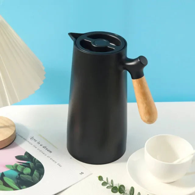 Portable NordicTherm insulated travel mug for hot tea or cold water, leak-proof stainless steel bottle for on-the-go.