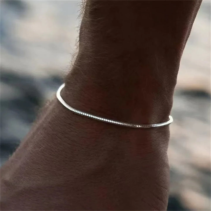 Silver minimalist stainless steel bracelet for men & women. Durable, sleek, & non-tarnishing everyday jewelry.