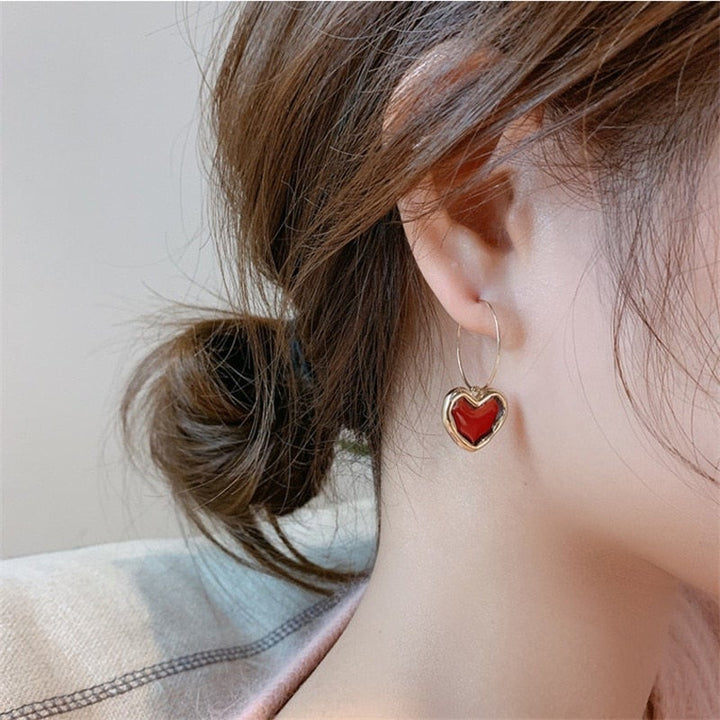 Red heart earrings for women, small and delicate, plated silver, romantic fashion accessory.
