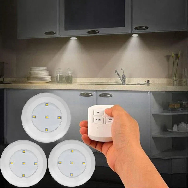Smart LED puck lights with remote, silver finish, illuminating kitchen cabinet interior