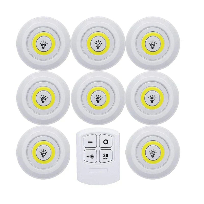 Smart LED puck lights mounted inside a dark display cabinet, highlighting decorative items