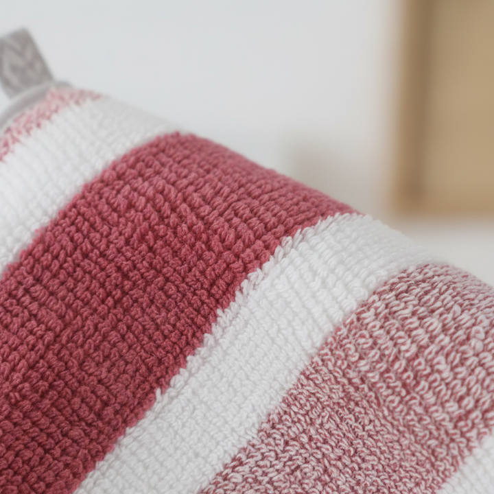 Stack of five soft coral fleece striped towels in neutral tones, ideal for bathroom set