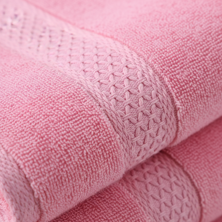 Vibrant, colorful cotton towels from the 'CottonJoy' 4-piece set draped over a modern bathroom rack.