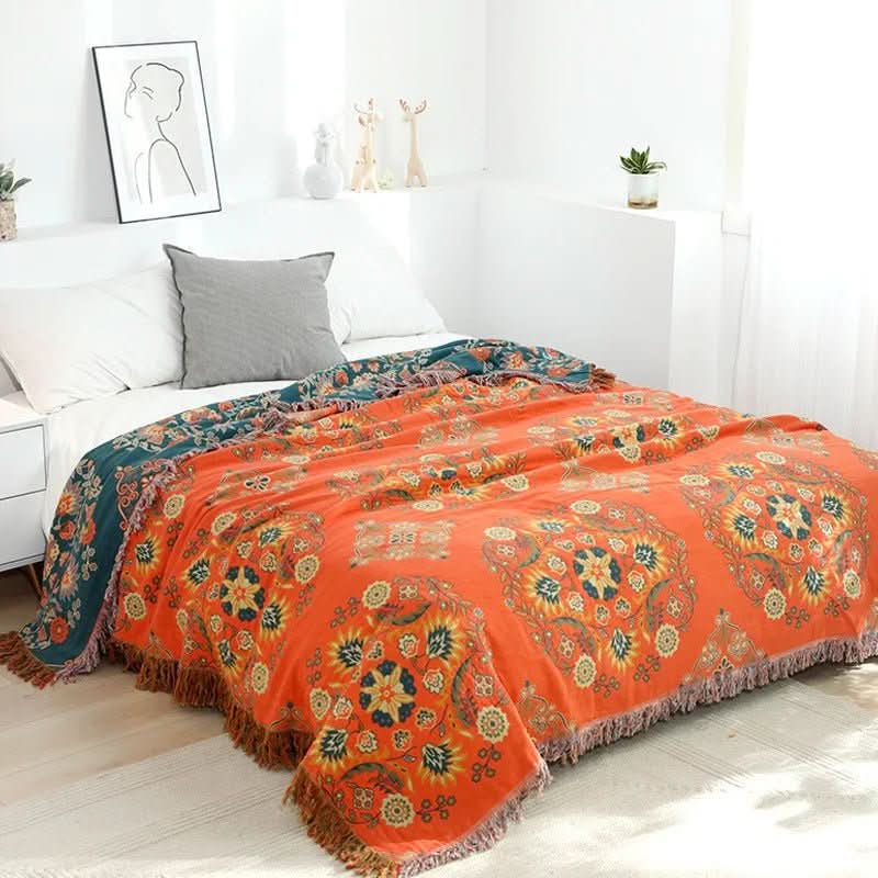 Soft boho cotton throw blanket in orange & yellow, perfect for a cozy living room or bedroom decor.