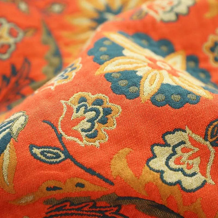 Textured boho cotton throw blanket, orange & yellow, adds a warm touch to any cozy home space.