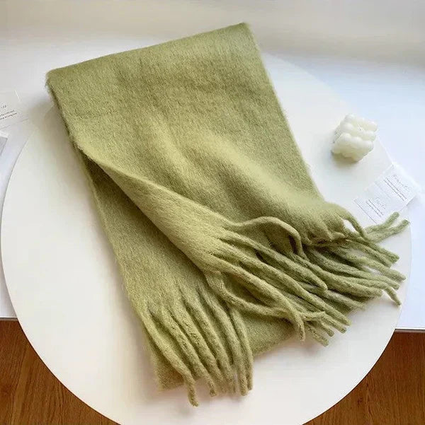 Cashmere scarf draped over a coat, illustrating it as a stylish and warm winter accessory