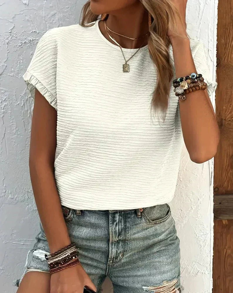 Close-up of the fabric texture of a women's soft cotton tee, showing quality.
