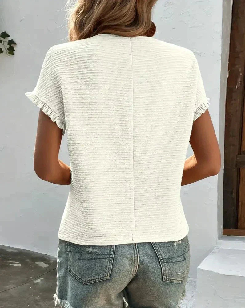 Model wearing a white Élodie women's soft cotton t-shirt, styled for casual everyday.