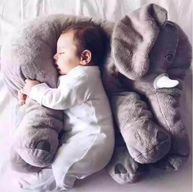 Soft grey baby elephant plush cuddle pillow, perfect for nursery decor & infant comfort. A sweet newborn gift.