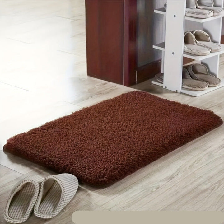 Elegant soft bath mat with geometric design, non-slip, absorbent, and comfortable.
