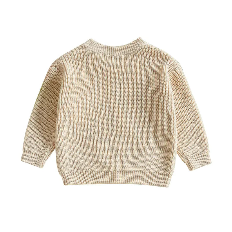 Cute white knit baby pullover with delicate embroidery, stylish and soft for toddlers.