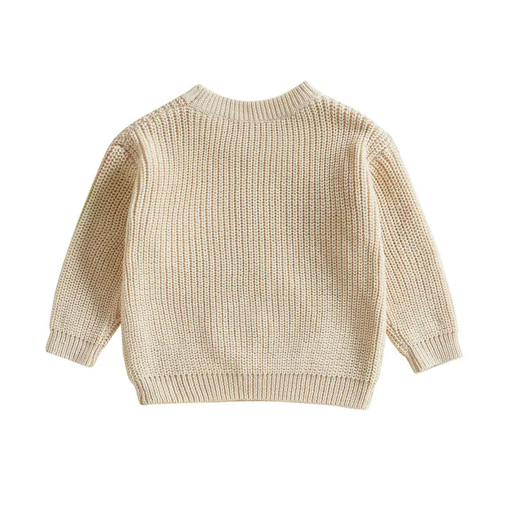 Cute white knit baby pullover with delicate embroidery, stylish and soft for toddlers.
