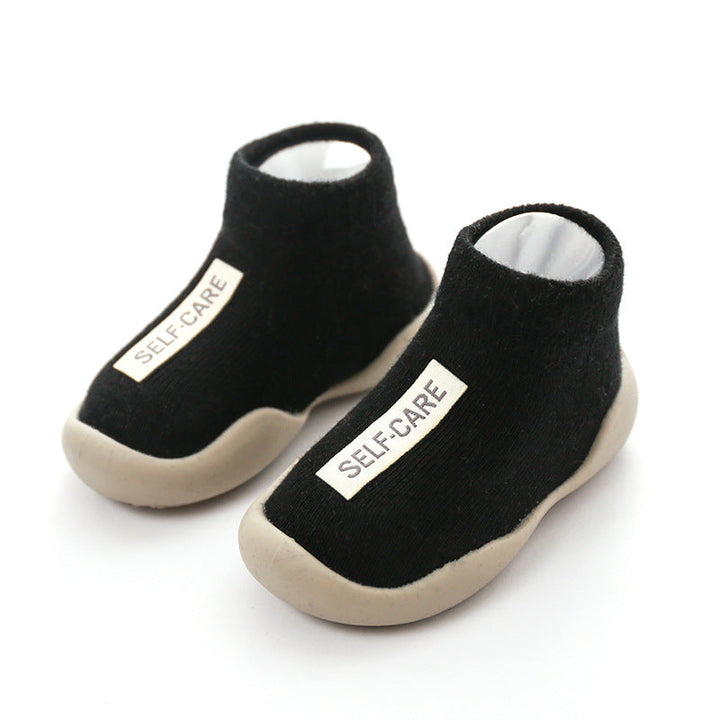 Detailed view of the soft knitted texture and anti-slip sole of toddler slippers