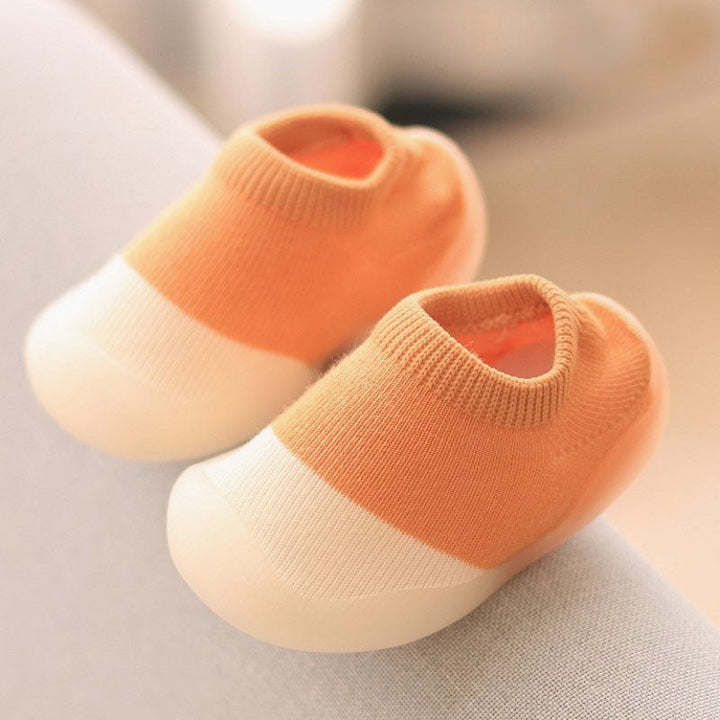 Toddler wearing cozy knitted anti-slip slippers, comfortable infant home footwear