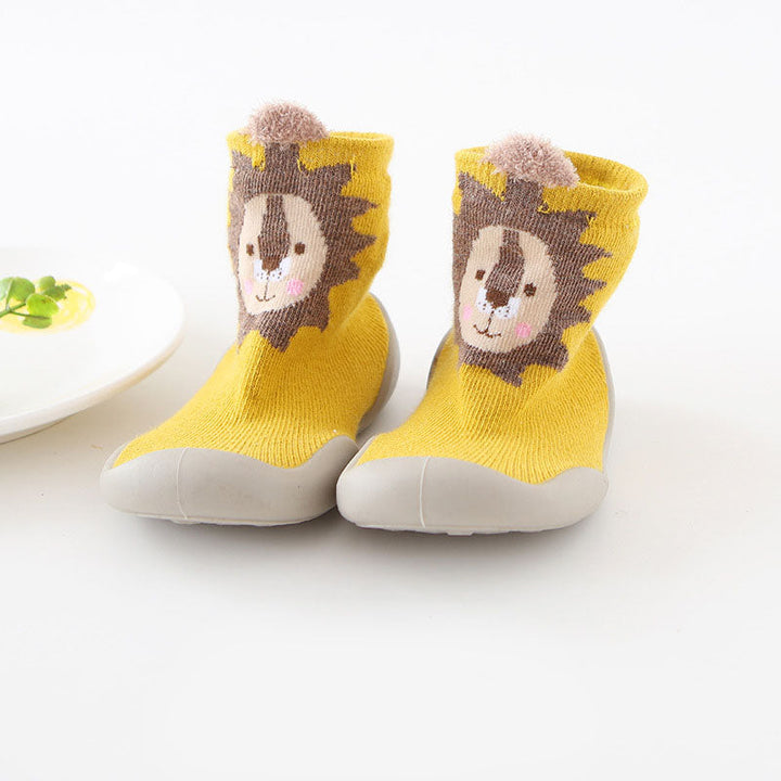 Close-up of anti-slip sole on white knitted toddler slippers, infant safety footwear