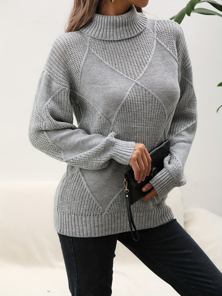 Women's soft knit turtleneck sweater with dropped shoulders. Perfect cozy top for winter and autumn fashion.