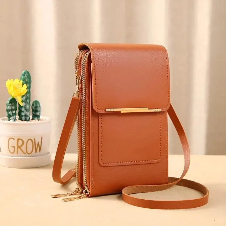 Secure women's leather crossbody bag, worn by model, ideal for travel & city life.