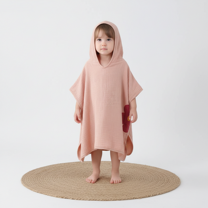 Kids' hooded poncho towel in breathable muslin, perfect for baby and toddler bath time