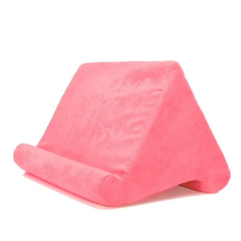 Hands-free tablet stand pillow comfortably supporting a device on a lap for viewing.