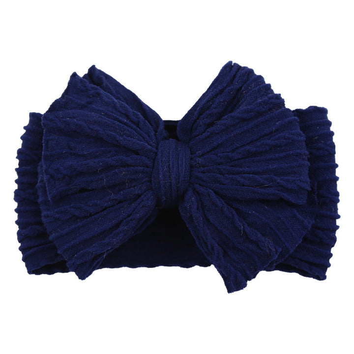 Children's soft pink nylon bow headband, comfortable and stylish infant wear.