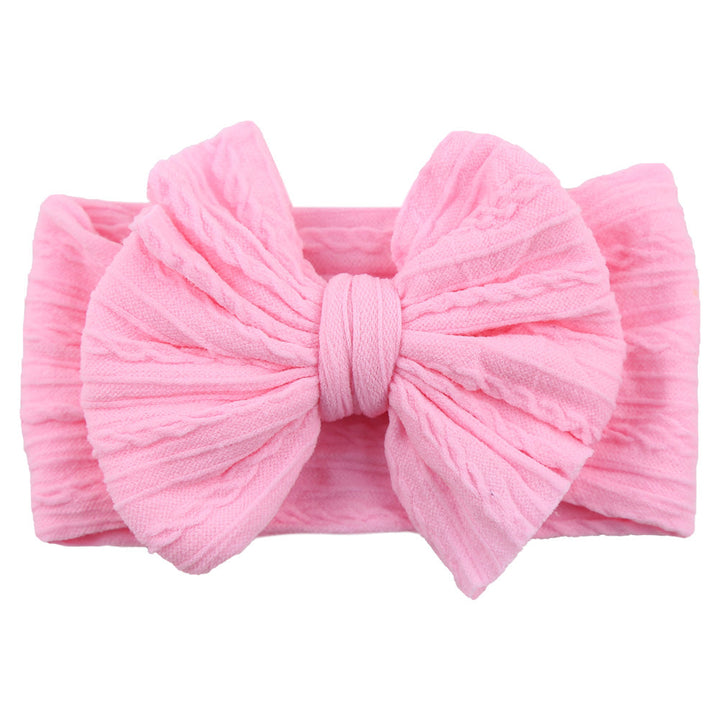 Baby accessory: yellow nylon bow headband on a white background, cute design.