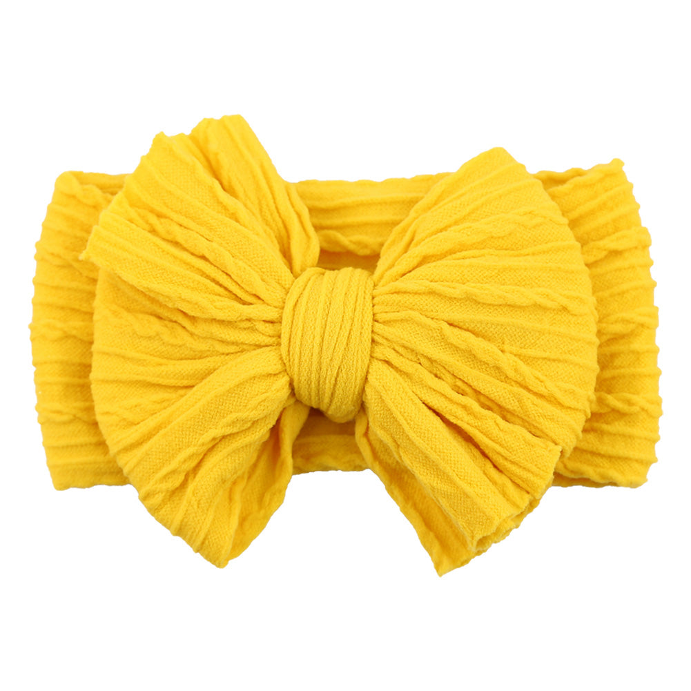 Close-up of a blue soft nylon bow headband, a stylish baby accessory.