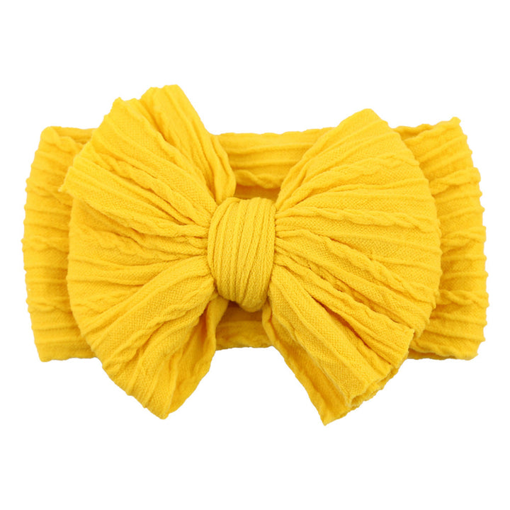 Close-up of a blue soft nylon bow headband, a stylish baby accessory.