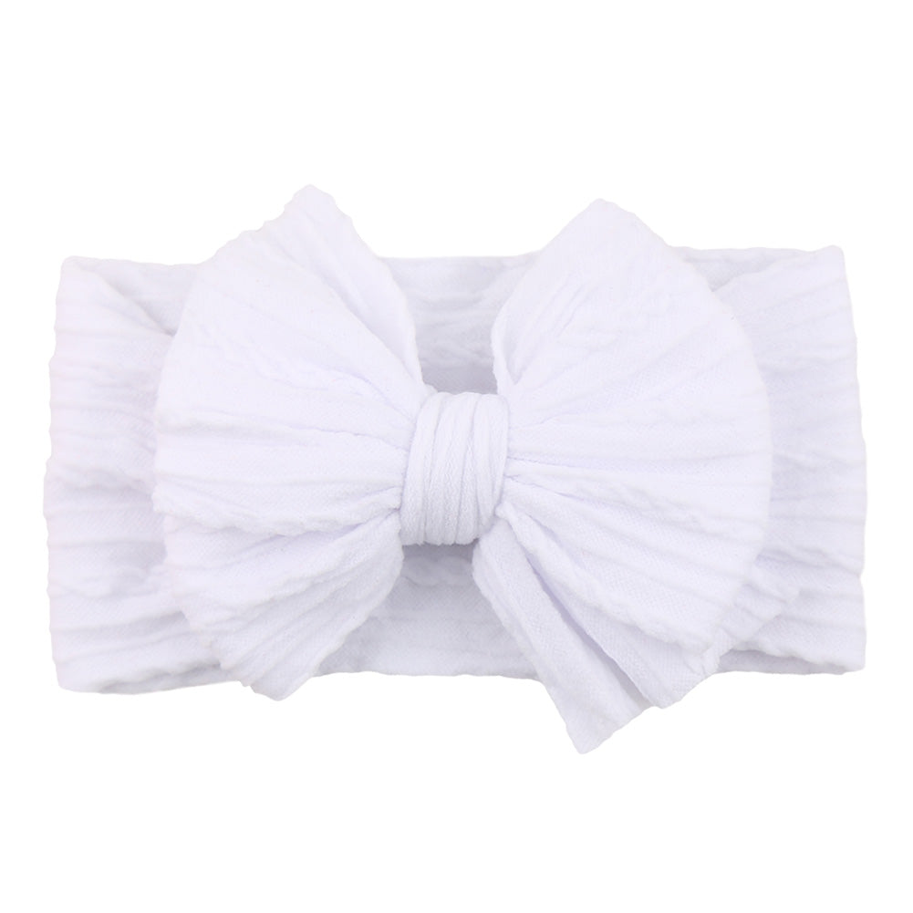 Infant fashion: child modeling a red nylon bow headband, comfortable for babies.
