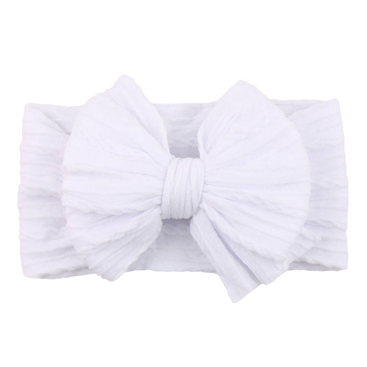 Infant fashion: child modeling a red nylon bow headband, comfortable for babies.