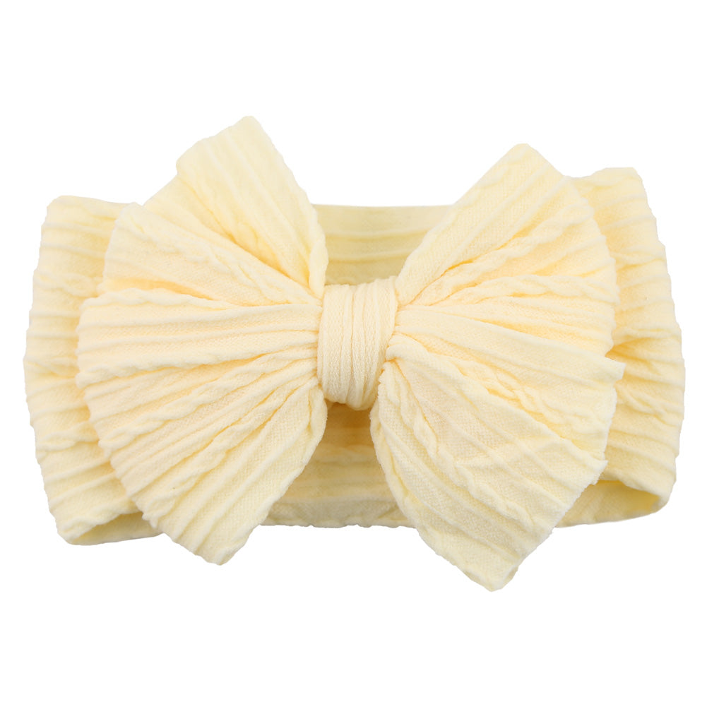 Multicolor pack of stretchy nylon bow headbands, essential children's accessory.