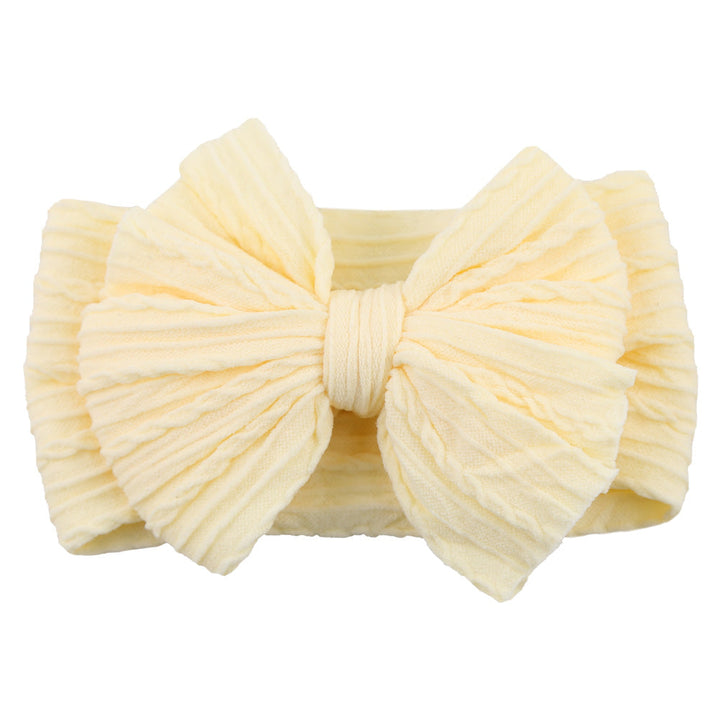 Multicolor pack of stretchy nylon bow headbands, essential children's accessory.