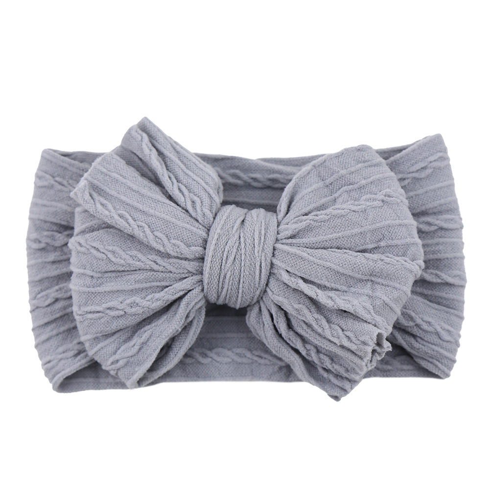 Collection of various colored nylon bow headbands, perfect children's accessories.