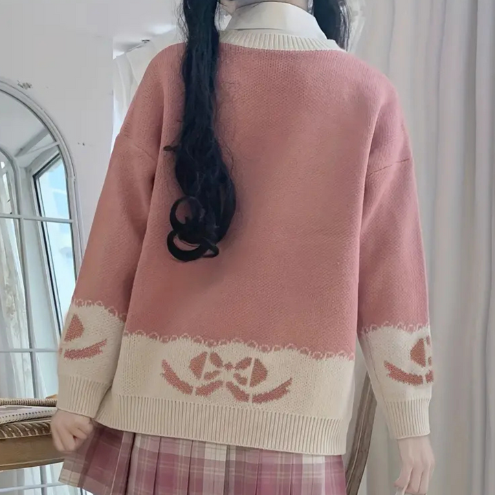 Loose-fit women's pink acrylic knit sweater with a classic round neck for casual comfort.