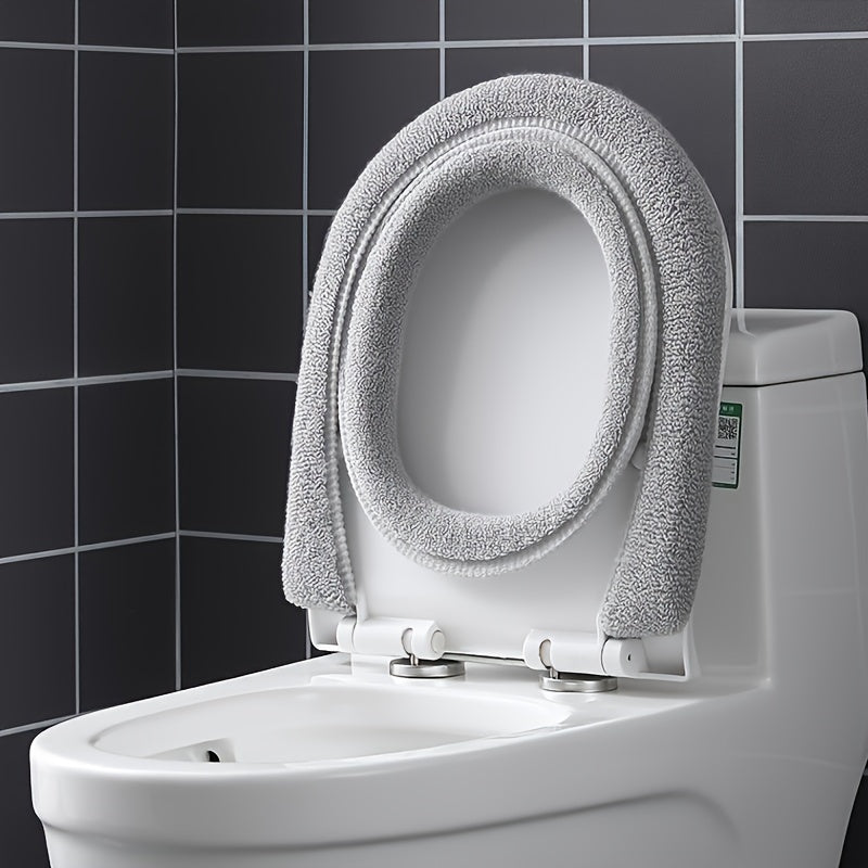 Green soft toilet seat cover, offering warm comfort and a hygienic polyester design for your bathroom.