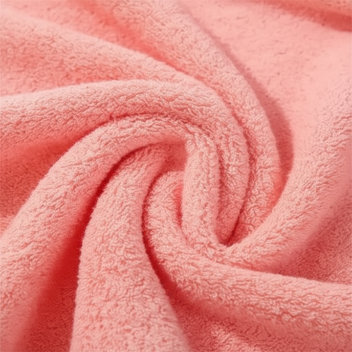 Plush ShowerJoy cotton bath towel in neutral color, ideal for quick drying