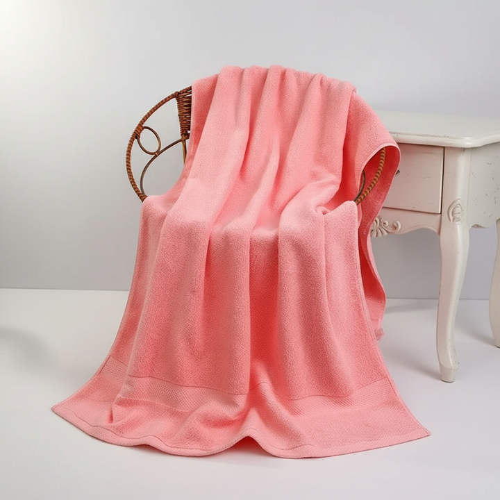 Absorbent ShowerJoy cotton bath towel draped over a rack in a modern bathroom