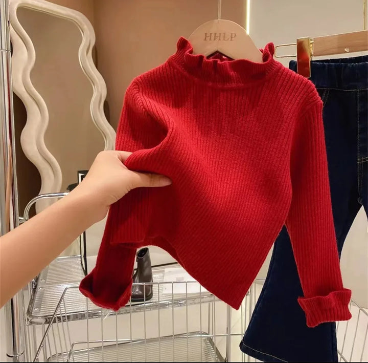 Close-up of a soft cotton knit, long sleeve sweater for toddlers, highlighting comfort and quality