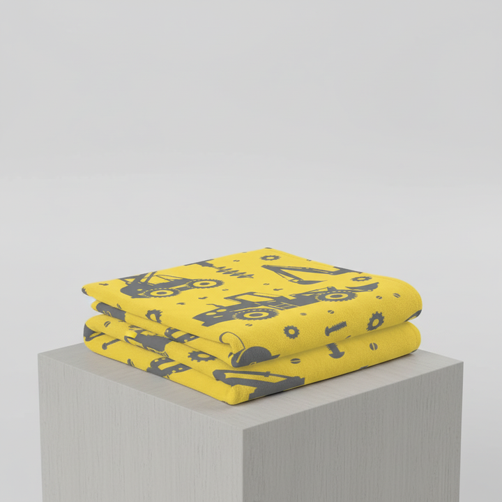 Absorbent children's towel set featuring vibrant construction machine design, perfect for bath time fun