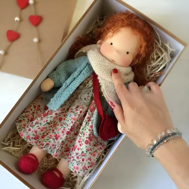Children's cuddly Waldorf doll, a handmade natural fiber toy for imaginative and nurturing play.