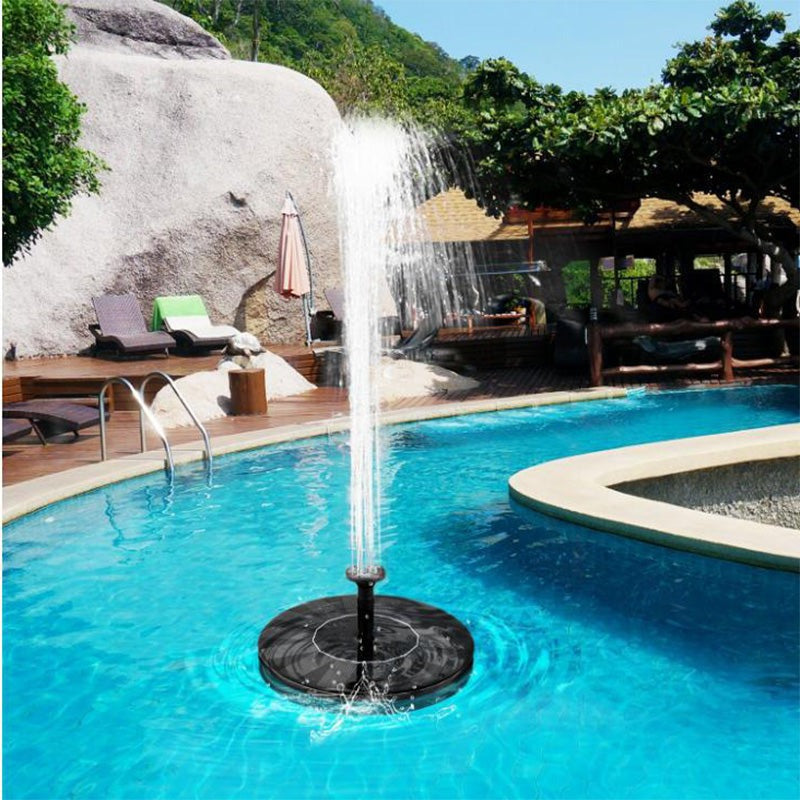 Solar floating fountain pump for garden pond. Eco-friendly water feature for outdoor decor and bird baths.