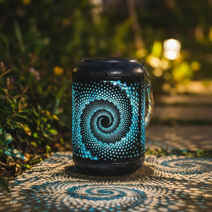 Solar Powered Garden Spiral Projection Light emitting a warm glow on a garden path at dusk.