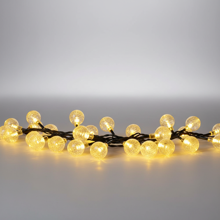 Weatherproof solar fairy lights draped around a patio umbrella, creating a cozy evening ambiance.