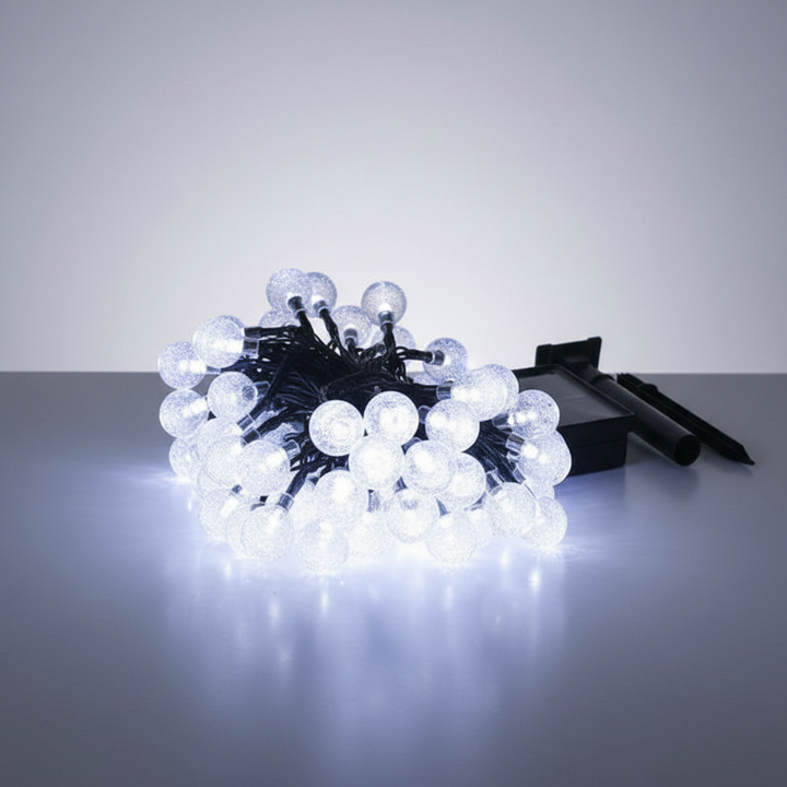 Solar garden lights, 'FairyGlim', providing enchanting illumination for a backyard scene.