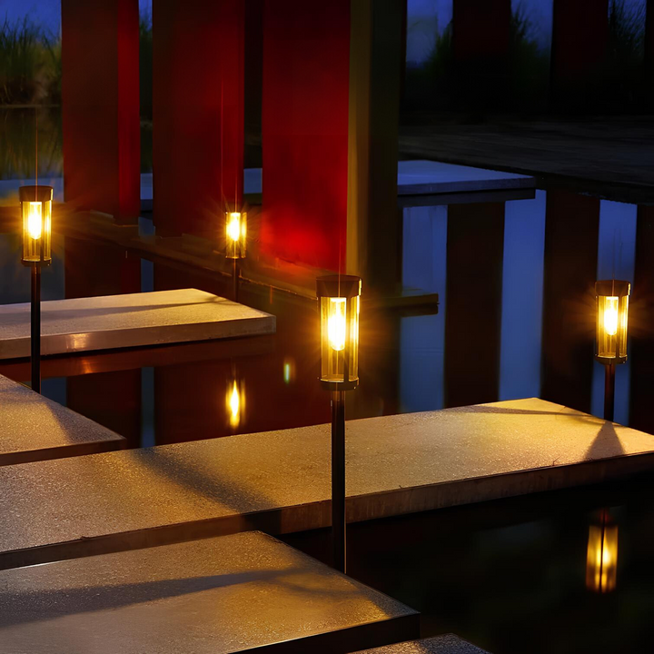 Close-up of a SolarFlare garden torch, showcasing the warm flickering flame for evening gardens